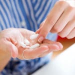 Woman taking a probiotic for Candida overgrowth