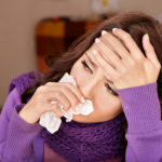 Woman suffering from flu symptoms